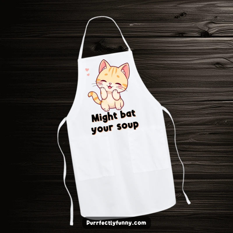 Funny apron illustrating a cat character hilariously batting at a detached whisker, making kitchen chores more enjoyable with feline humor.