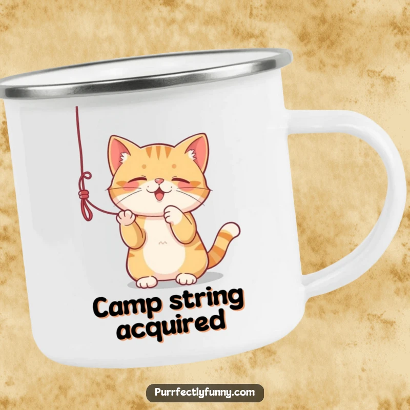 Funny camping mug with a cat playing with a dangling string, perfect for outdoor adventures.
