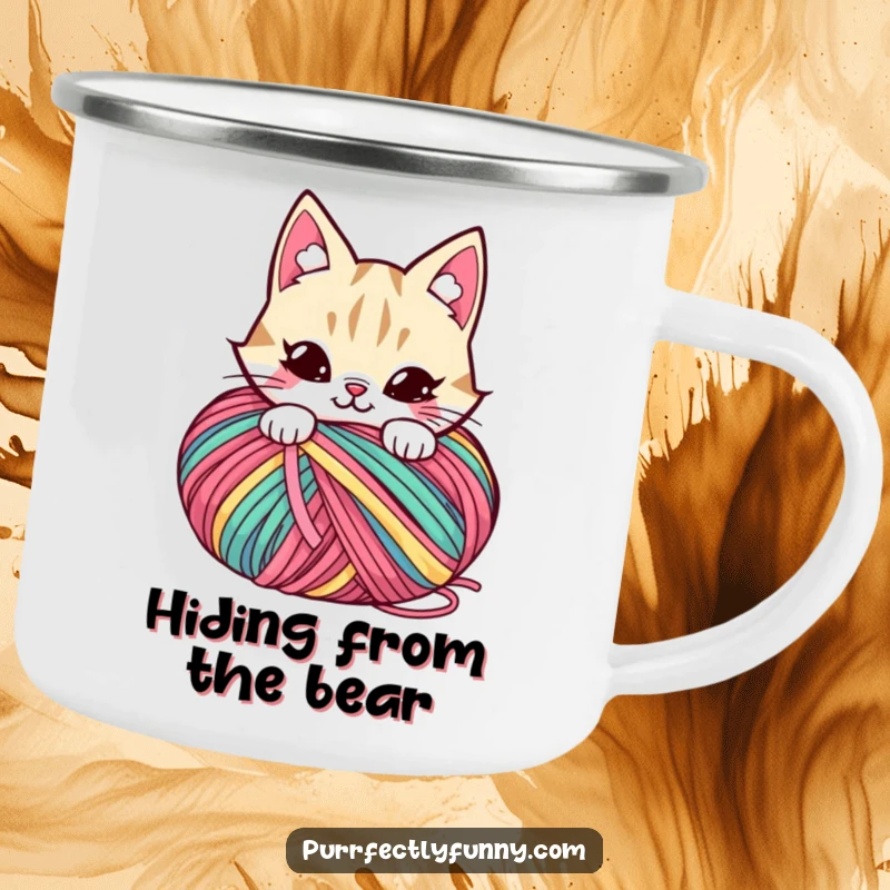 Funny camping mug with a mischievous cat character hiding behind a large ball of colorful yarn.