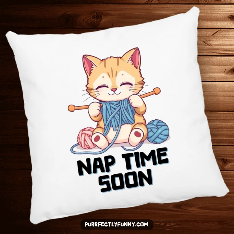 Funny cat pillow depicting a cat struggling with oversized knitting supplies, cozy and humorous decor.