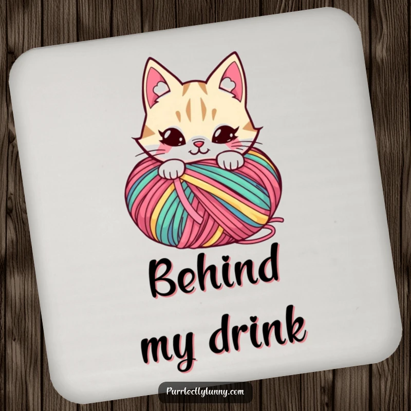 Funny drink coaster featuring a mischievous cat character hiding behind a large ball of colorful yarn.