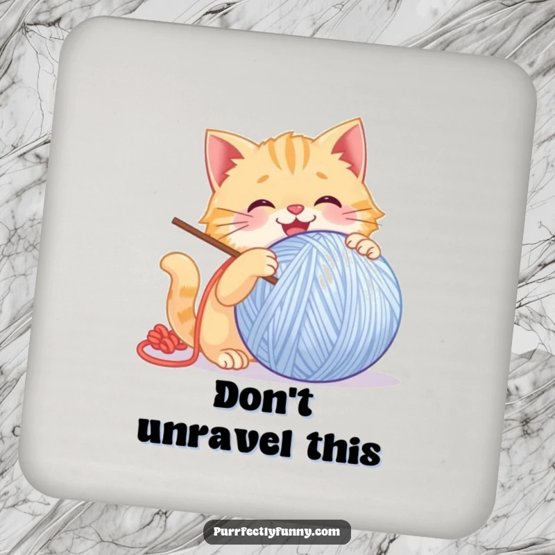 Funny Cat Coaster: A decorative coaster with a humorous image of a cat gleefully batting a giant, smiling ball of yarn.