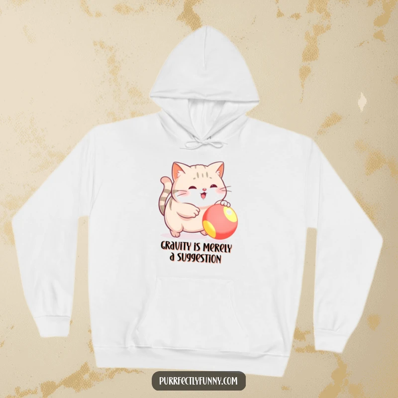 Funny hoodie with a plush plump cat enthusiastically chasing a colorful, bouncy ball, radiating pure playful energy.