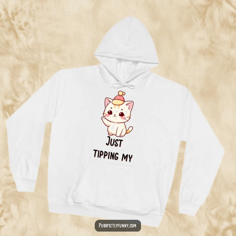 Funny cat wearing a tiny hat and tipping it with a paw, depicted on a cozy hoodie.