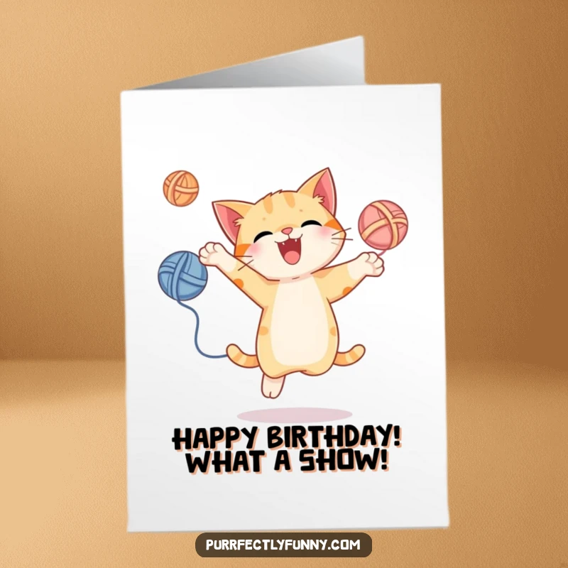 Funny Free Printable Birthday Card: A joyful cat leaps mid-air, energetically juggling three colorful yarn balls for birthday cheer.