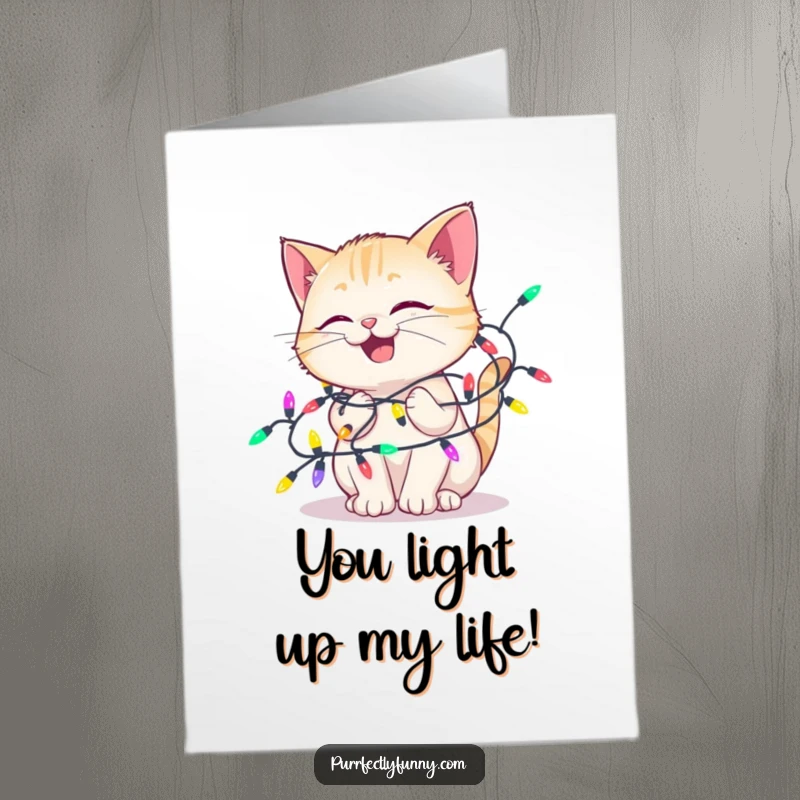 Funny Free Printable Birthday Card: A cat looks utterly delighted while happily tangled in a colorful string of festive lights.