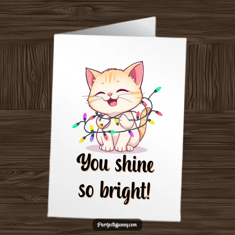 Funny Free Printable Congratulations Card: A cat beams with delight, playfully entangled in colorful lights, celebrating your success with joy.