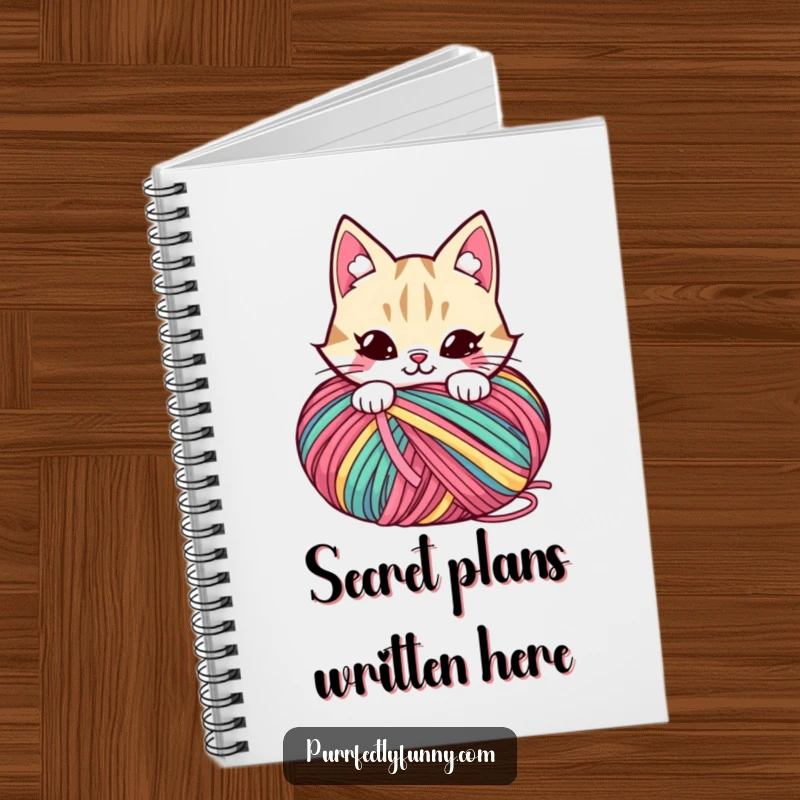 Funny notebook with a mischievous cat character hiding behind a large ball of yarn, with a grin.