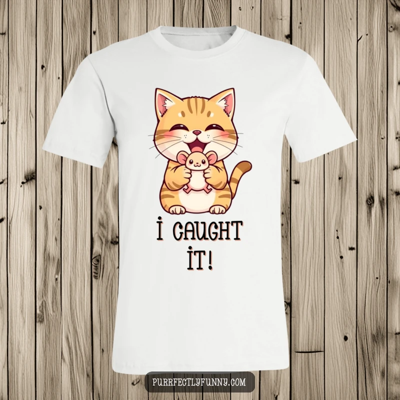 Funny t-shirt with a cat triumphantly holding a toy mouse, showing off a proud, victorious grin.