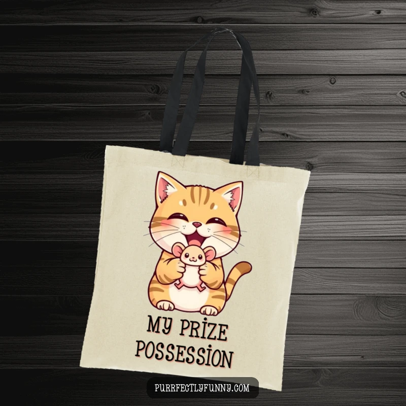 Funny tote bag with a triumphant cat holding a small toy mouse, perfect for carrying items.