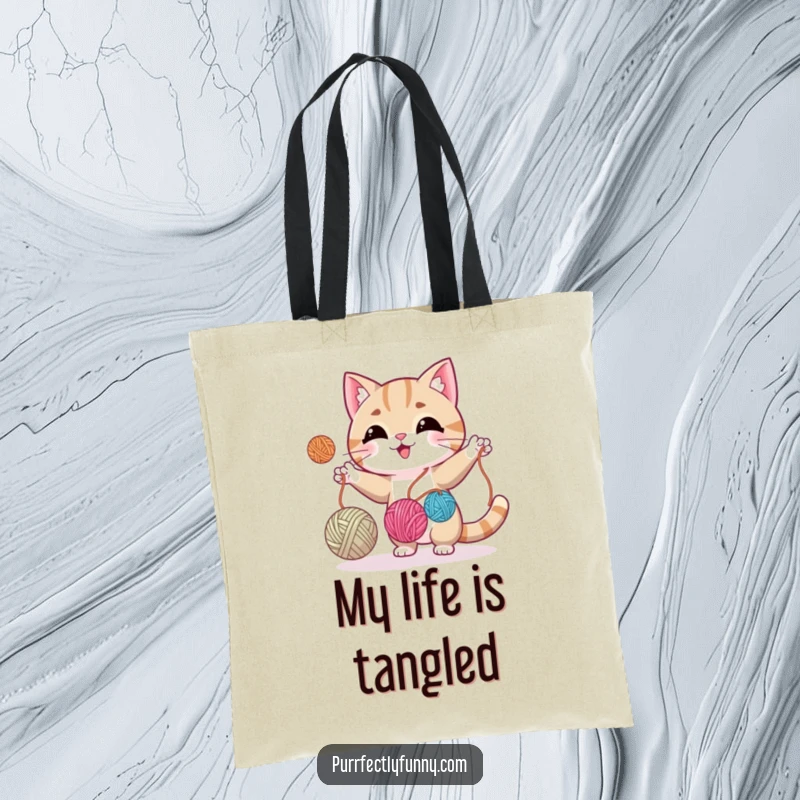 Funny cat mid-juggle with three yarn balls, adding a touch of playful skill to this functional tote bag.