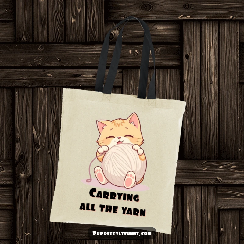 Funny Tote Bag illustrating a cat in mid-pounce, enthusiastically batting at an oversized ball of yarn.