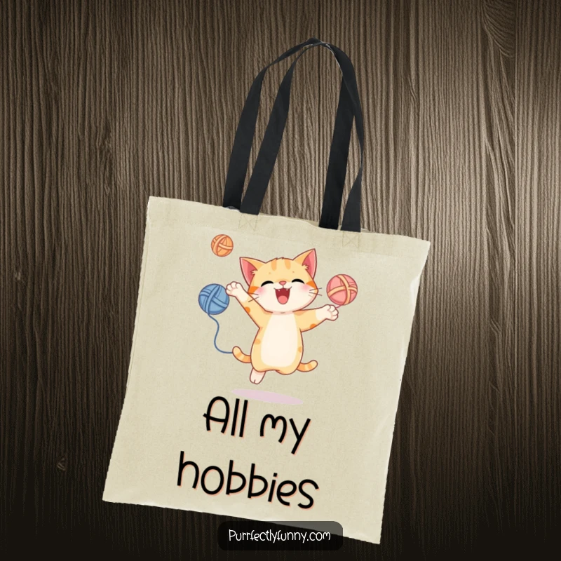 Funny tote bag with a cat energetically juggling yarn balls, perfect for carrying items with a dose of playful humor.
